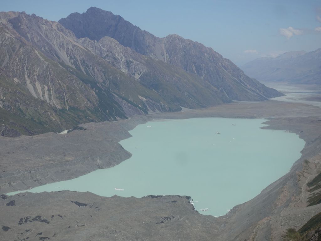 this is the edge of the glacier that melts into a lake, with a few visible icebergs