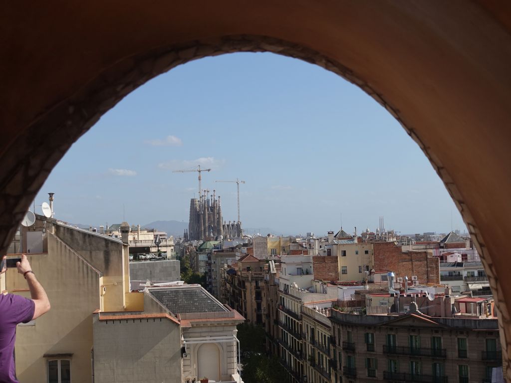 one of the building's arches has a view on the unfinished Sagrada Familia