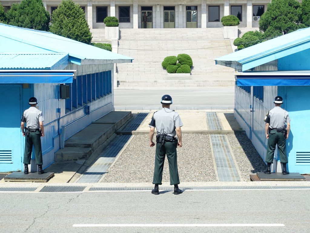 the south korean soldiers stand there all day with their fists clenched starting at the opponent (a single poor north korean guy with no so good looking clothes) on the other side