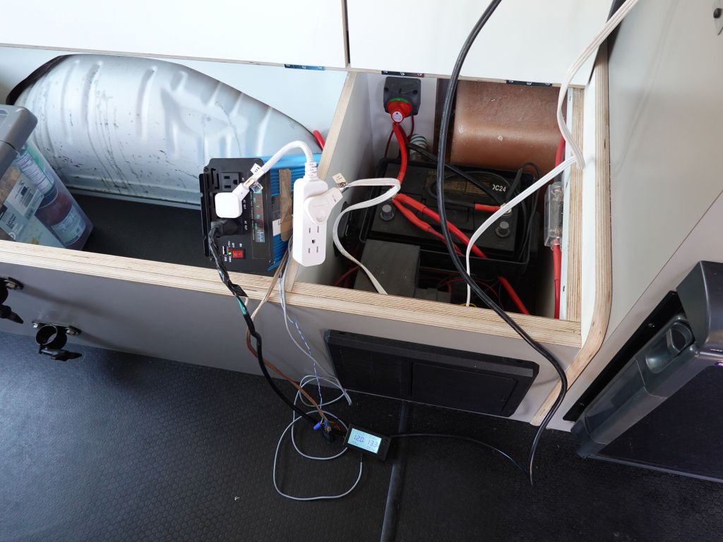 my big 3000W inverter didn't quite fit in the battery cabinet, but there was a hole to feed cables to the battery
