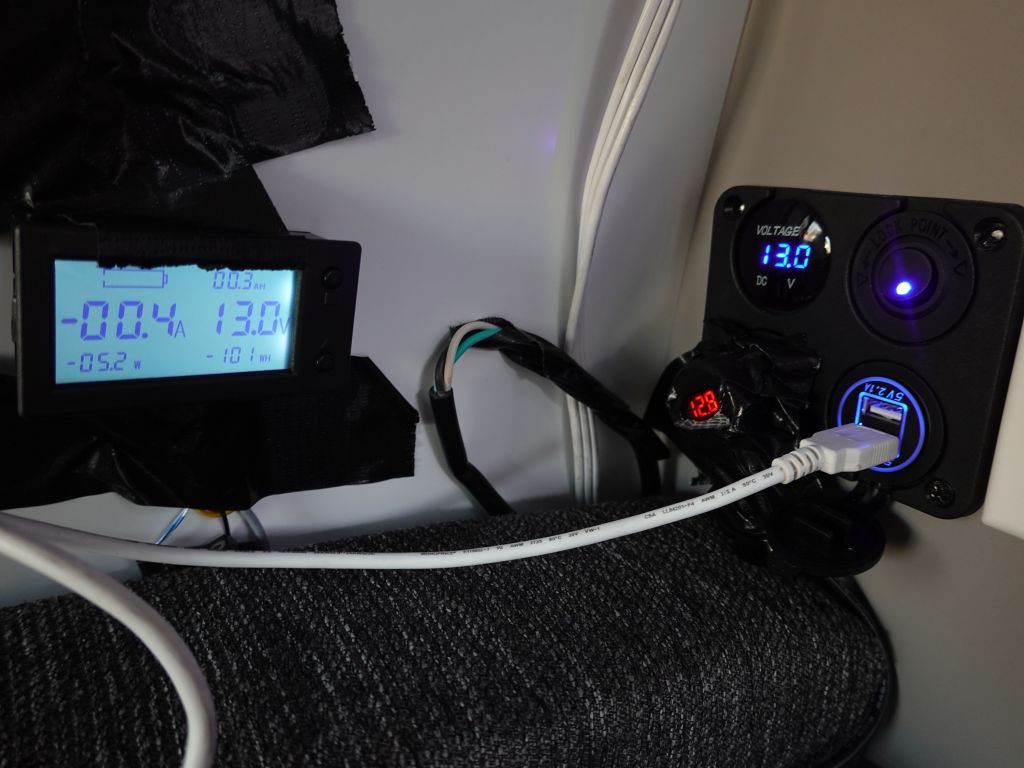 our Kuga had been upgraded with a 12V and USB plug coming from the battery, my inverter meter is on the left. The 12V plug there was only good for 10A though, so you can't use it for an inverter