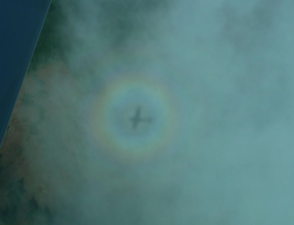 cool shadow of our plane in the clouds with a rainbow around it. Neat!
