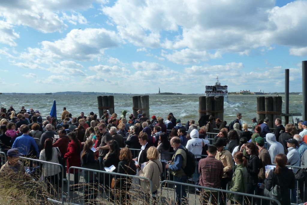 line of people going to the statue of liberty
