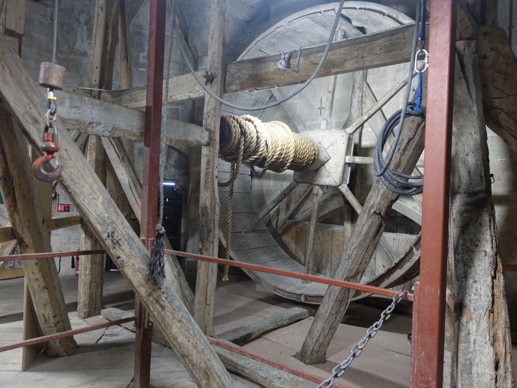 the big wheel was used to take building material to the top of the church to build the huge spire that was added (and added enough weight to almost collapse the entire church)